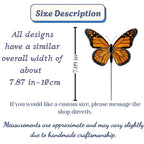 Handmade stained glass monarch butterfly plant stake displayed in a green ceramic planter