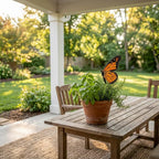 Handmade stained glass monarch butterfly plant stake displayed in a green ceramic planter
