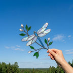 Handcrafted iridescent stained glass dragonfly suncatcher on a branch casting colored shadows, perfect memorial or Mother's Day window decor gift.