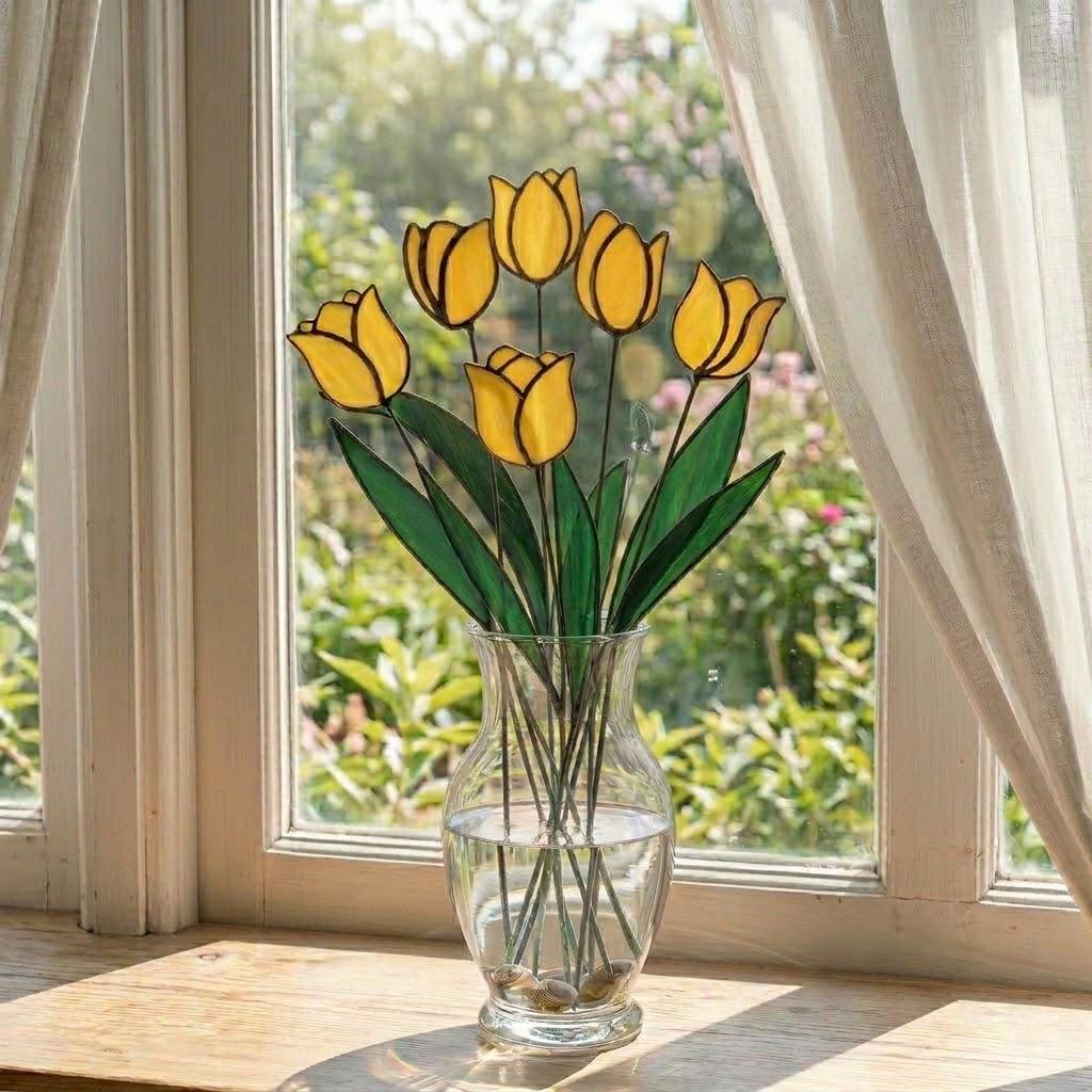 Handcrafted stained glass tulip flowers on long wire stems arranged in a sunlit vase casting colored shadows, perfect everlasting Mother's Day bouquet gift.