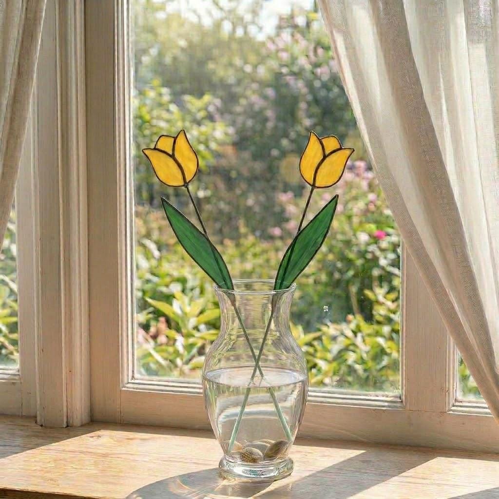 Handcrafted stained glass tulip flowers on long wire stems arranged in a sunlit vase casting colored shadows, perfect everlasting Mother's Day bouquet gift.