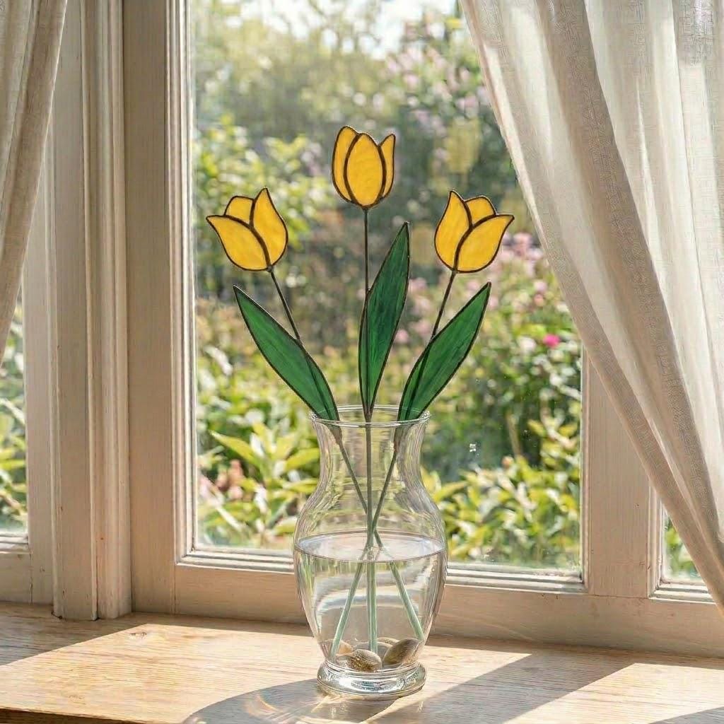 Handcrafted stained glass tulip flowers on long wire stems arranged in a sunlit vase casting colored shadows, perfect everlasting Mother's Day bouquet gift.