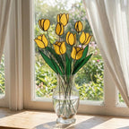 Handcrafted stained glass tulip flowers on long wire stems arranged in a sunlit vase casting colored shadows, perfect everlasting Mother's Day bouquet gift.