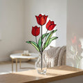 Handmade 3D red tulip stained glass flower standing on a solid walnut wood base, casting vibrant colored shadows in hard sunlight, perfect for Mother's Day gift and botanical cottagecore desk decor.
