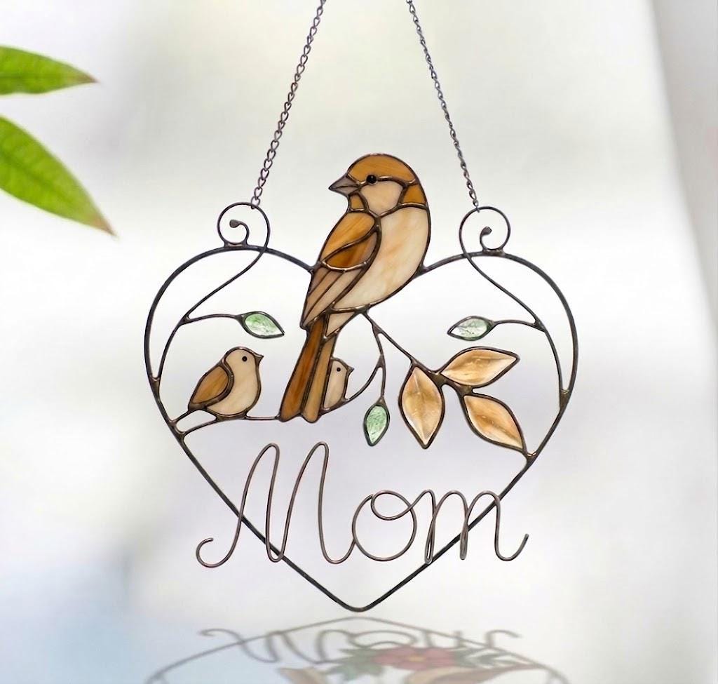 Stained glass cardinal mother and baby bird suncatcher in a heart frame with the word Mom, handmade window hanging gift.