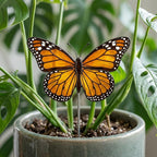 Handmade stained glass monarch butterfly plant stake displayed in a green ceramic planter